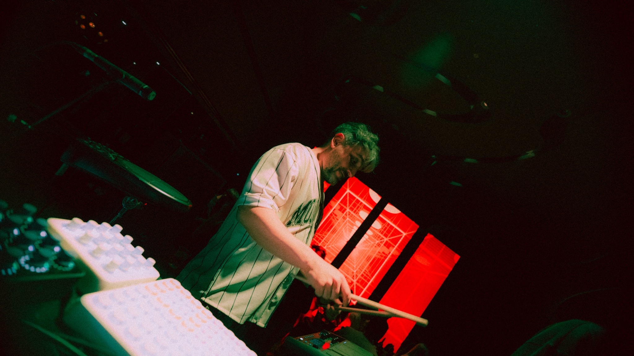 Gerçek Dorman performing a hybrid electronic live set with drumsticks