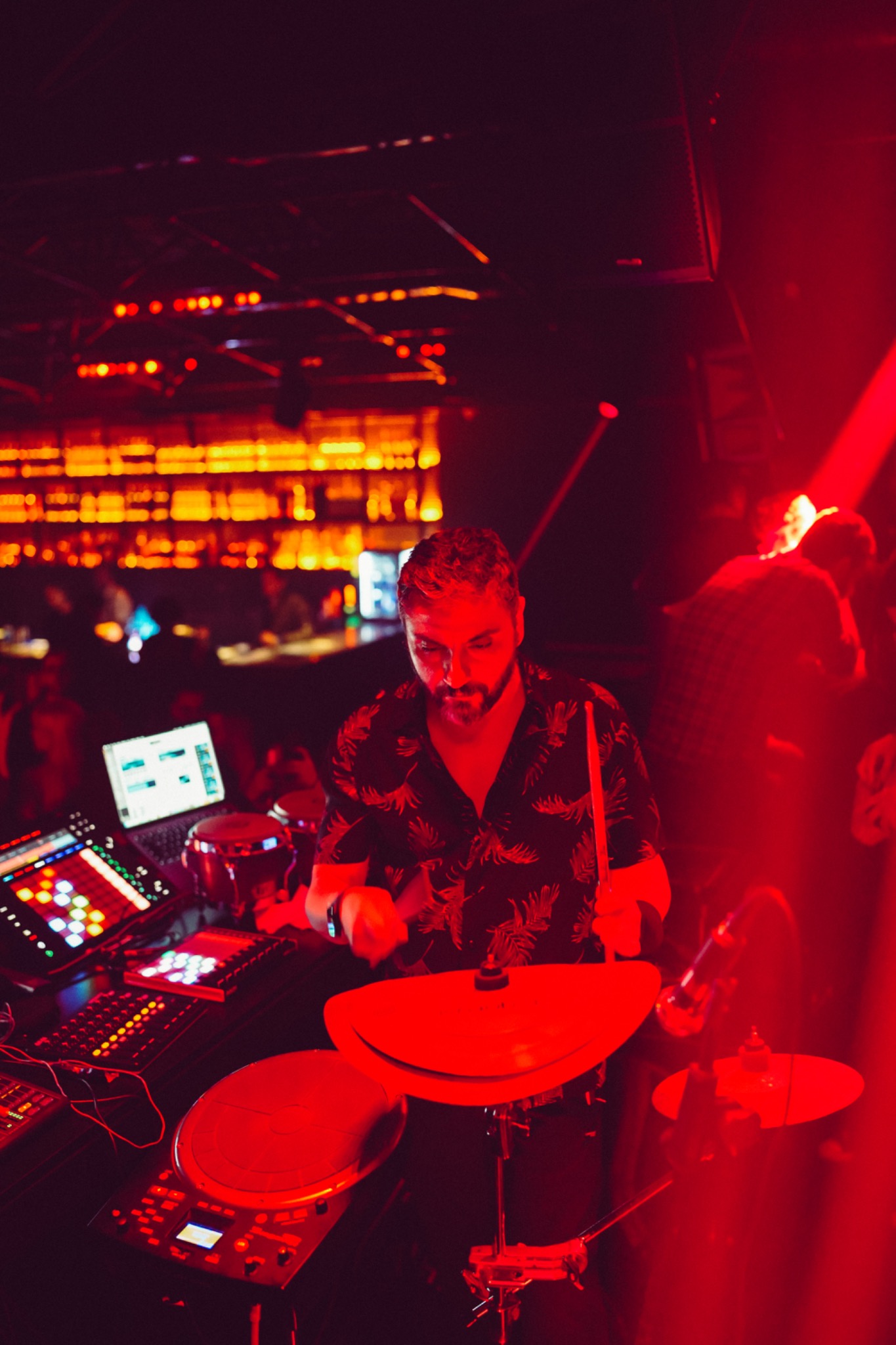 Gerçek Dorman performing on electronic drums under red stage light